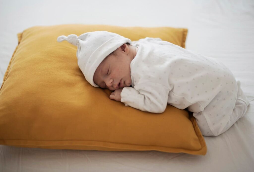 baby sleeping sitting up folded in half