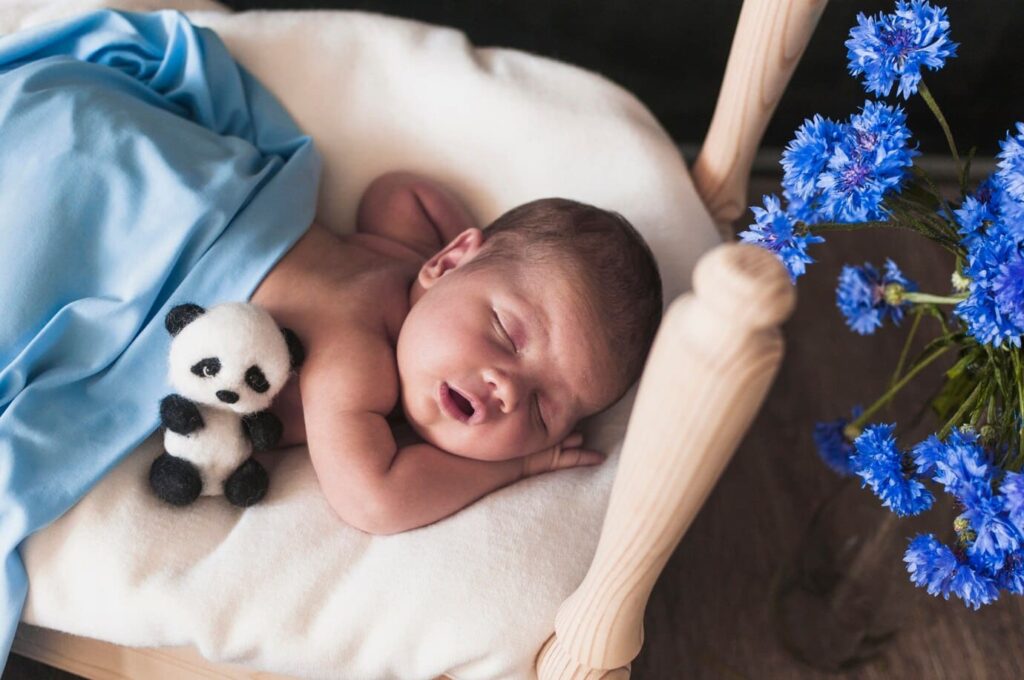 baby sleeping sitting up folded in half