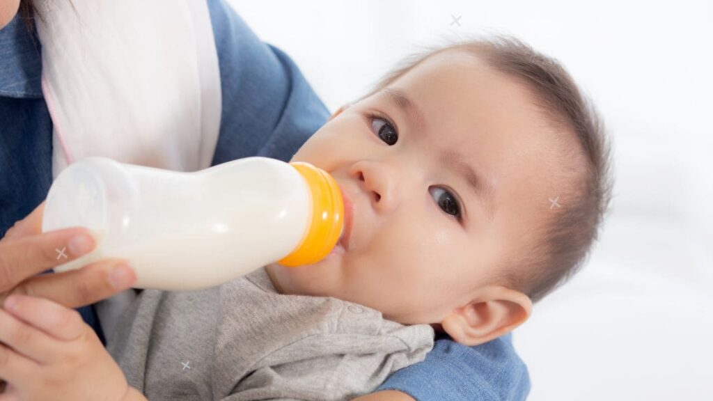 Baby Chewing on Bottle Nipple 5